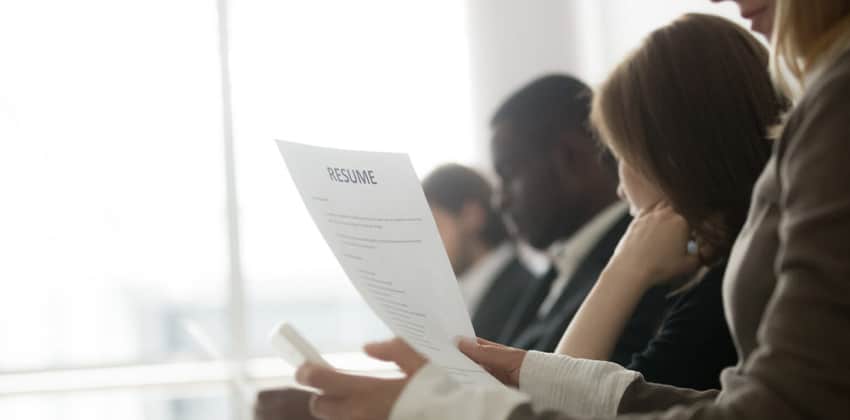 a group of people reviewing a resume